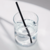 6-inch Black Cocktail hemp straw in a short glass of water