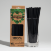 100-count pack of black 8-inch long, 6mm wide compostable hemp straws next to a stack of black hemp straws