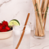 8-inch standard brown hemp straw in a water glass with lime and wrapped straws in the background