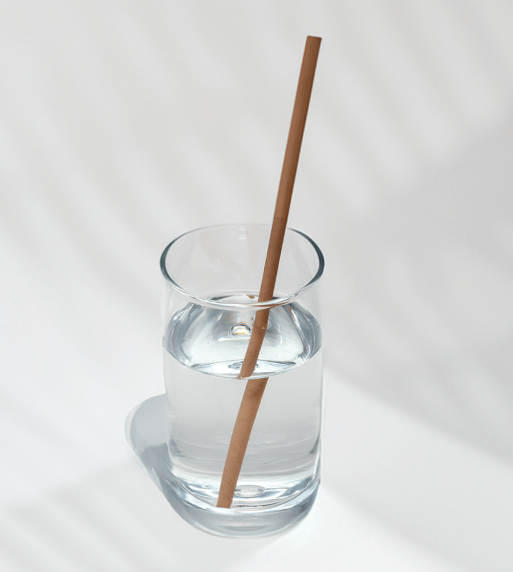 10-inch jumbo hemp straw in a glass of water