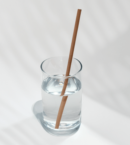 10-inch jumbo hemp straw in a glass of water